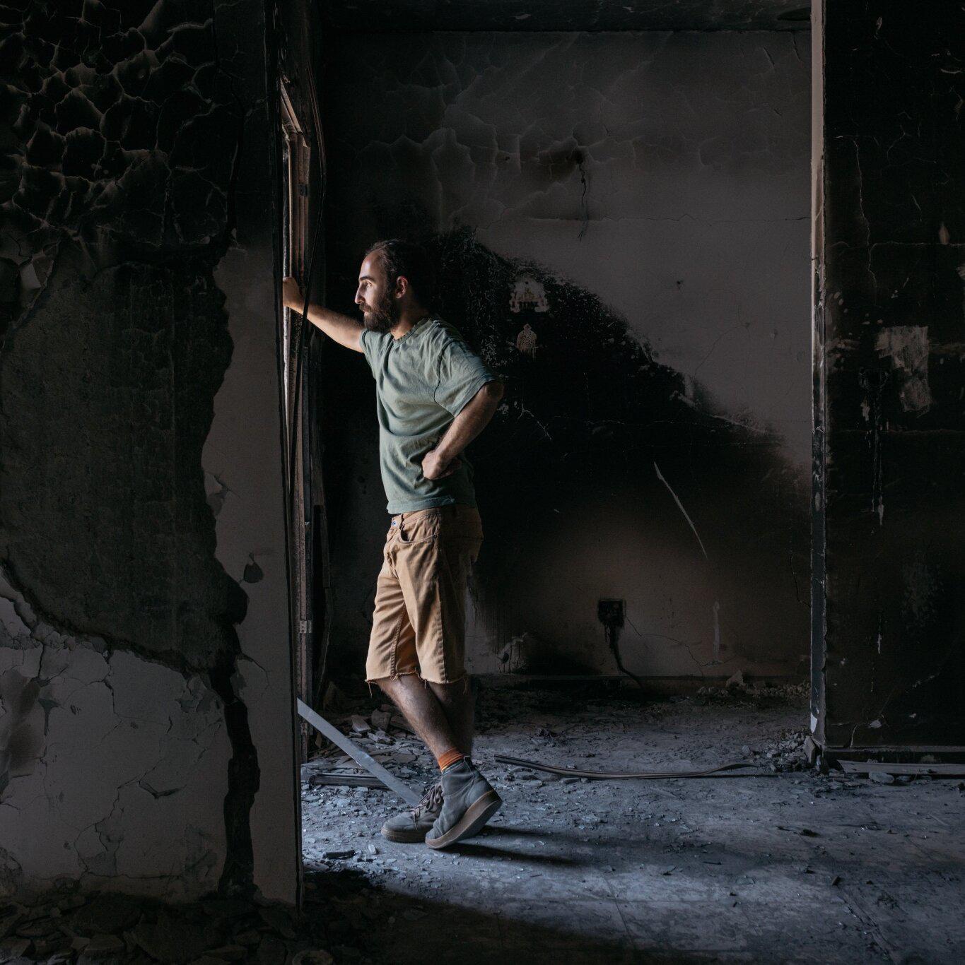Yonatan Zeigen in Kibbutz Be’eri, Israel, in August, visiting the home where his mother, Vivian Silver, was killed during the Oct. 7 massacre.