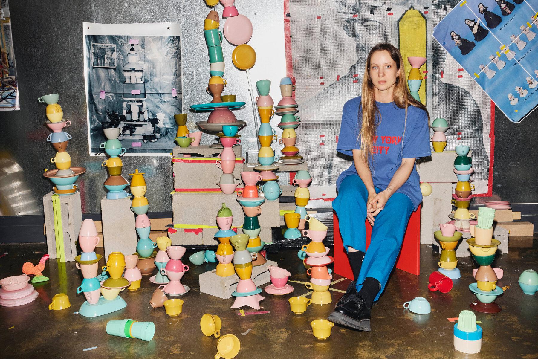 Sara Cwynar, photographed in her Brooklyn studio with her collection of 1950s-era melamine cups and plates.