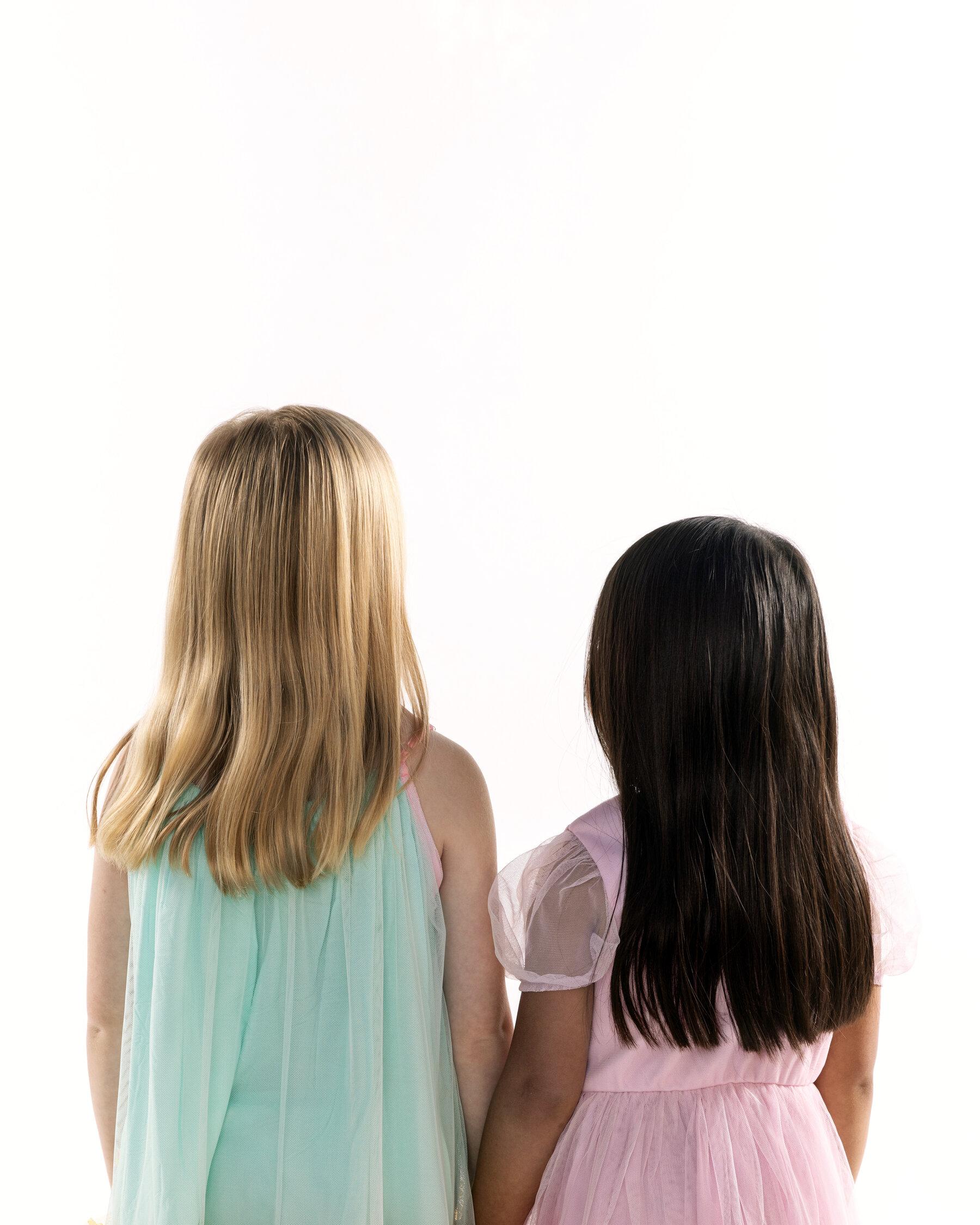 Zoë and May, both 5, were born to each other’s genetic parents.