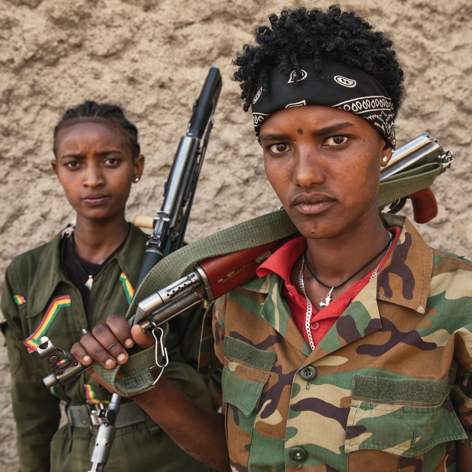 From left, Mekdes, 21, and Tihune, 22, are members of Fano, which is fighting against the central government, in Amhara. Mekdes, who joined more than a year ago, said her family supported her decision.