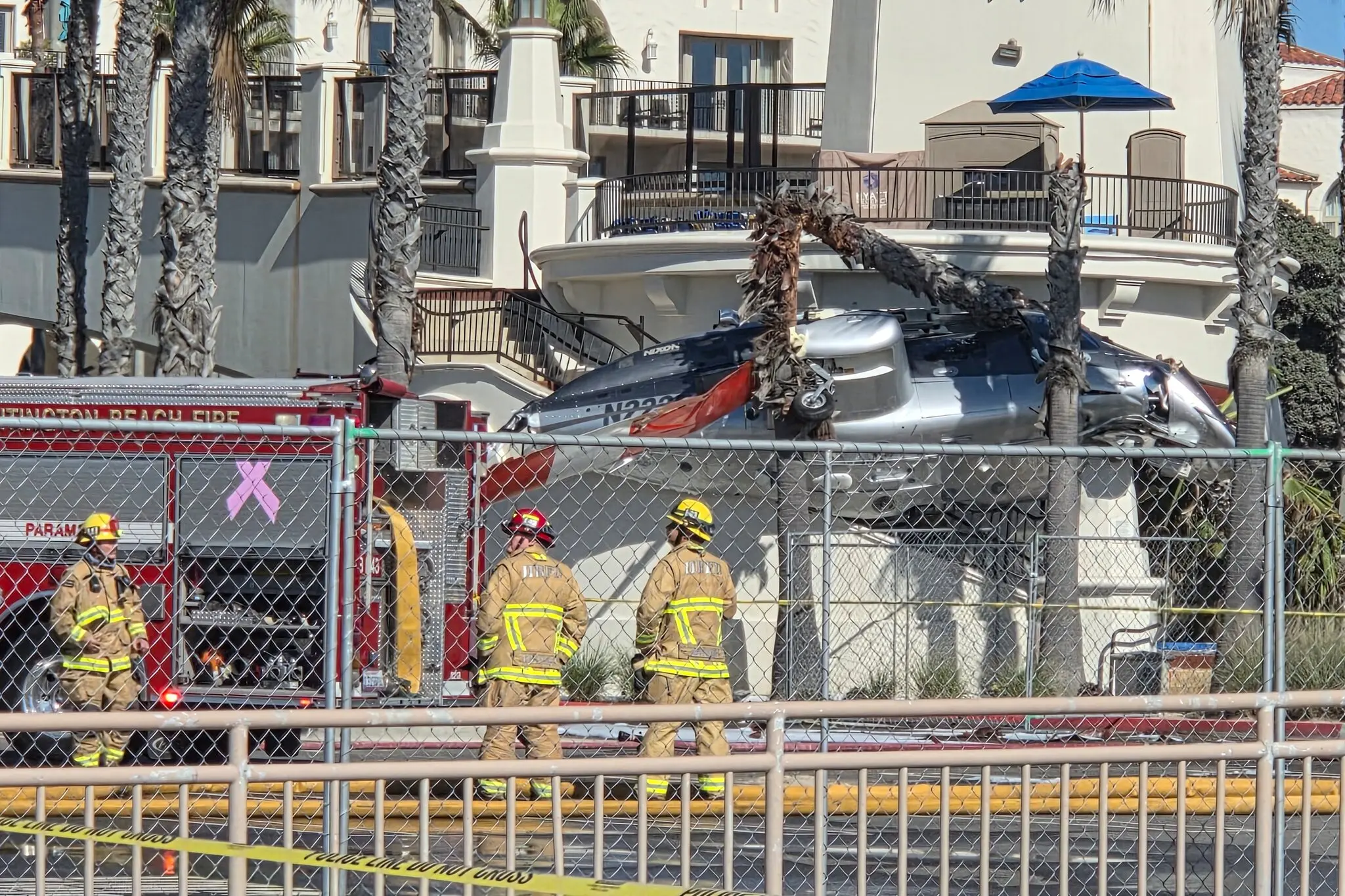 A helicopter near a building in Huntington Beach, Calif., on Saturday.