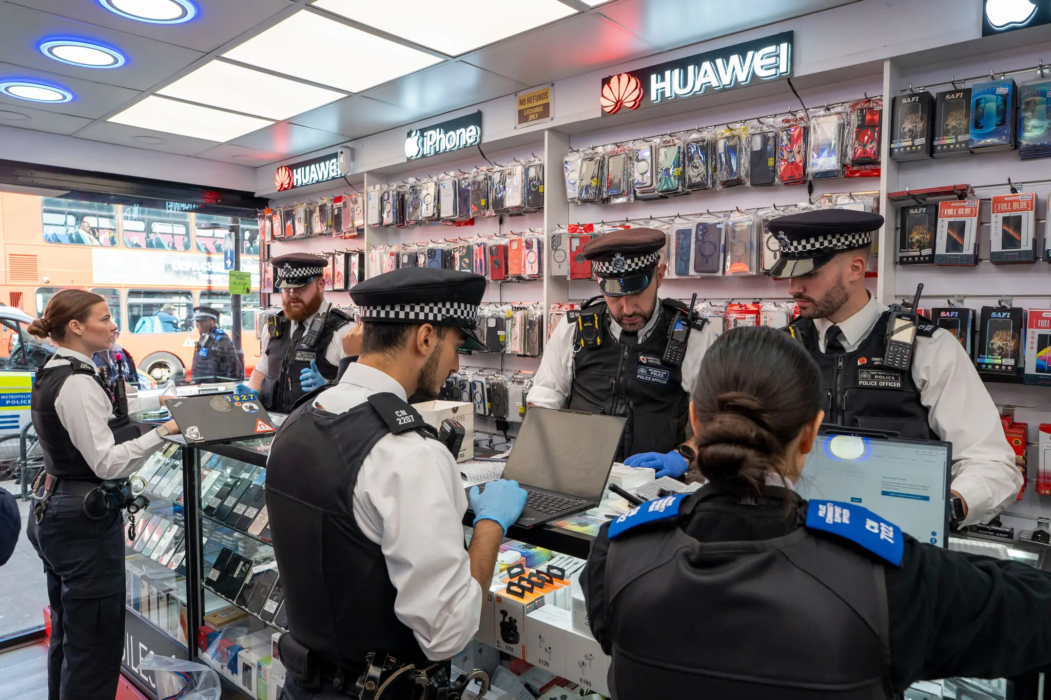 Police officers searching a secondhand phone shop in north London last month.