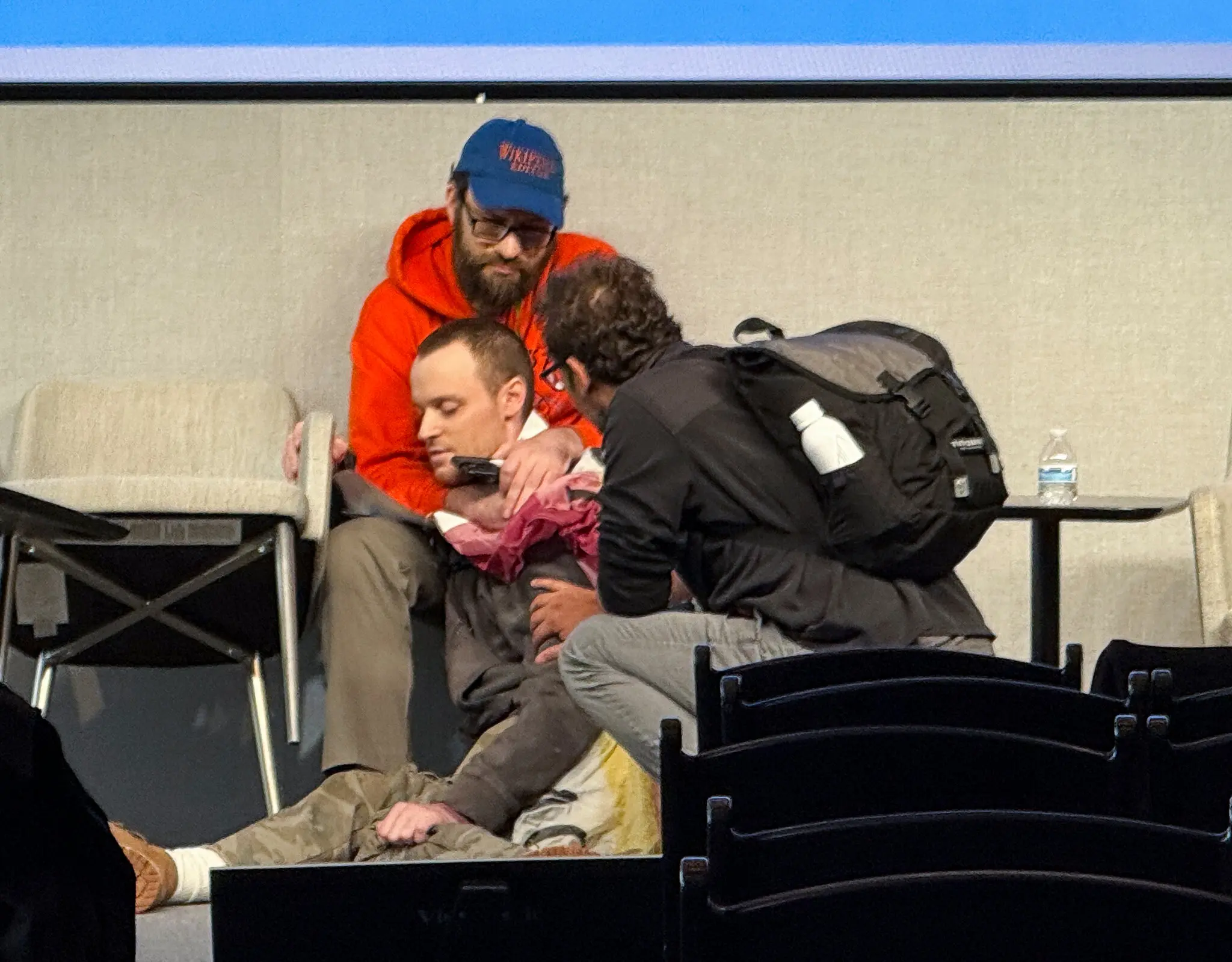 Richard Knipel, rear, rushed to grab a man with a gun after witnesses said the man threatened to shoot himself at a Wikipedia conference in Manhattan on Friday.