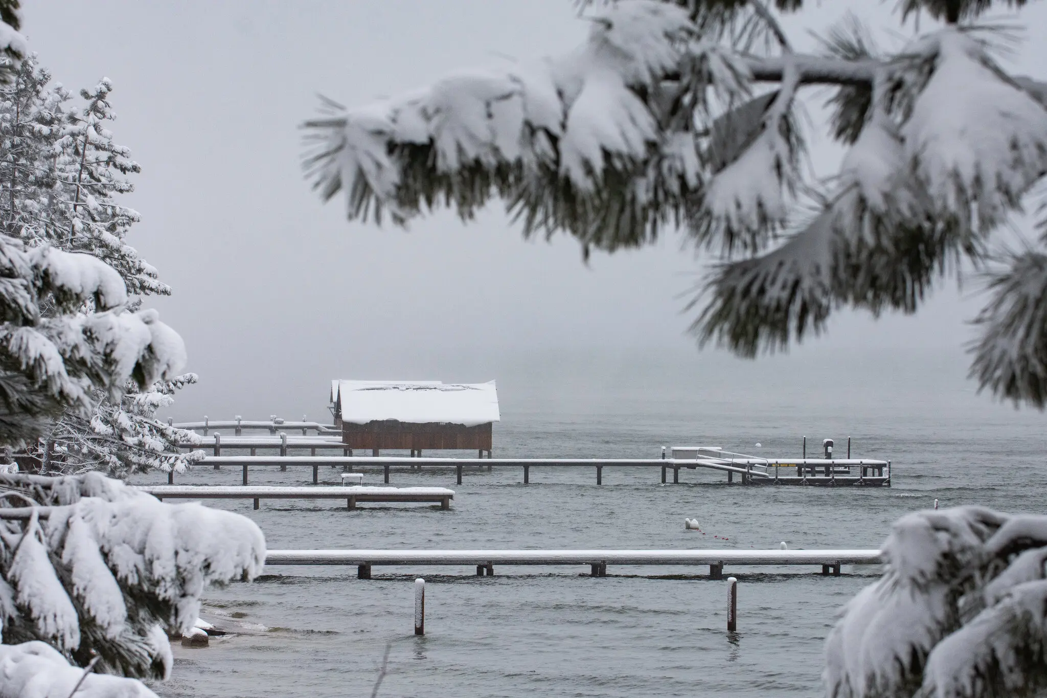 Piers are covered with snow during the start of a March 2024 blizzard in Lake Tahoe, Calif.
