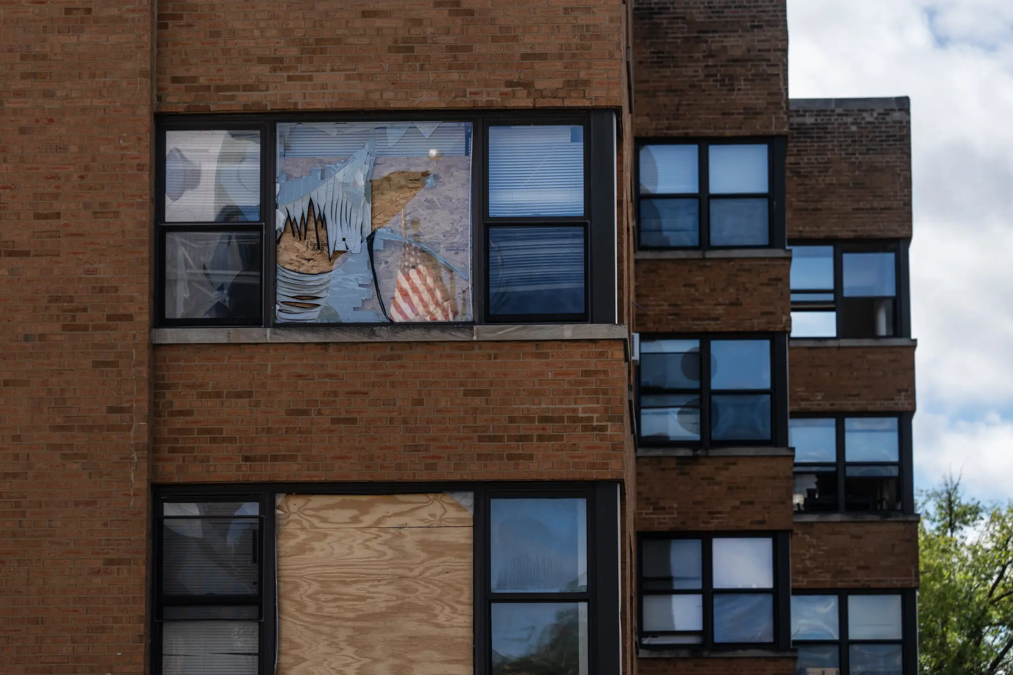 Windows are boarded up at an apartment building in Chicago’s South Shore neighborhood where federal agents staged a massive raid.
