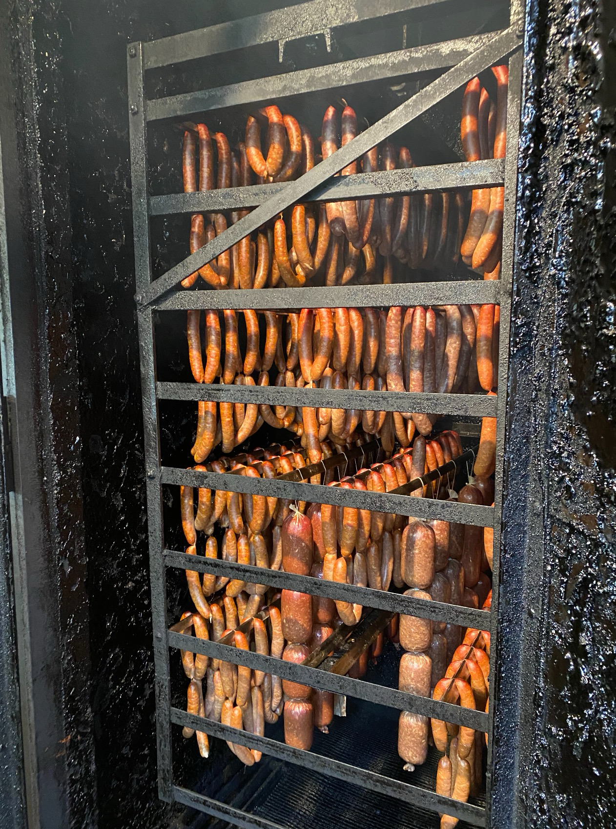 Sausages in the smokehouse at Otto’s Sausage Kitchen in Portland, Ore. Natural animal casings are typically more costly than plant-based ones.