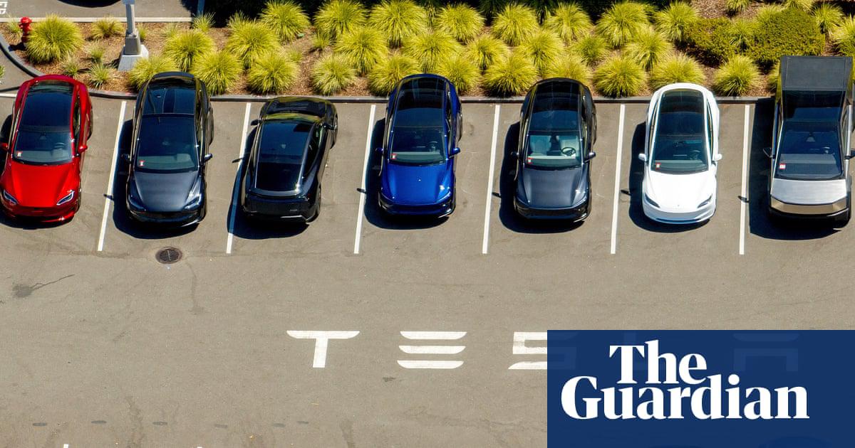 Tesla vehicles line a parking area at the company's factory in Fremont, California.