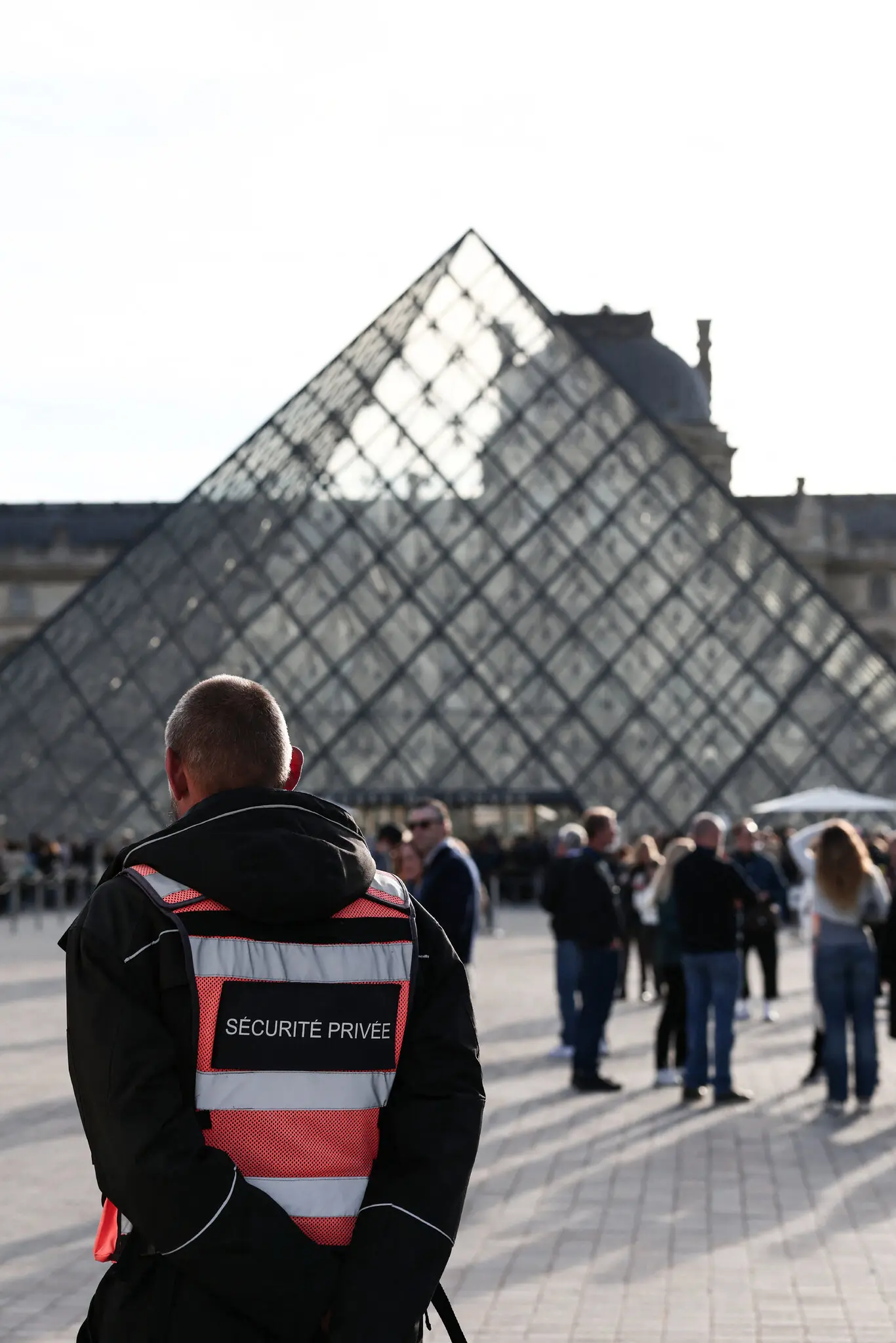 A security guard wearing a safety vest at the Louvre Museum in Paris on Wednesday. High-visibility safety jackets have become a symbol of authority.