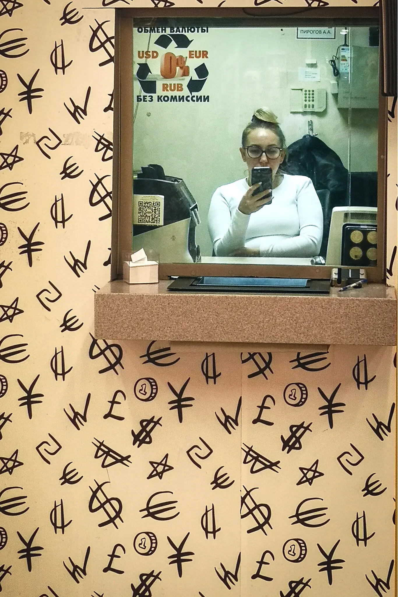 An employee checking her phone at a currency exchange in Moscow in February. For years, President Vladimir V. Putin of Russia has railed against foreign tech companies for their unwillingness to bend fully to Kremlin rules.