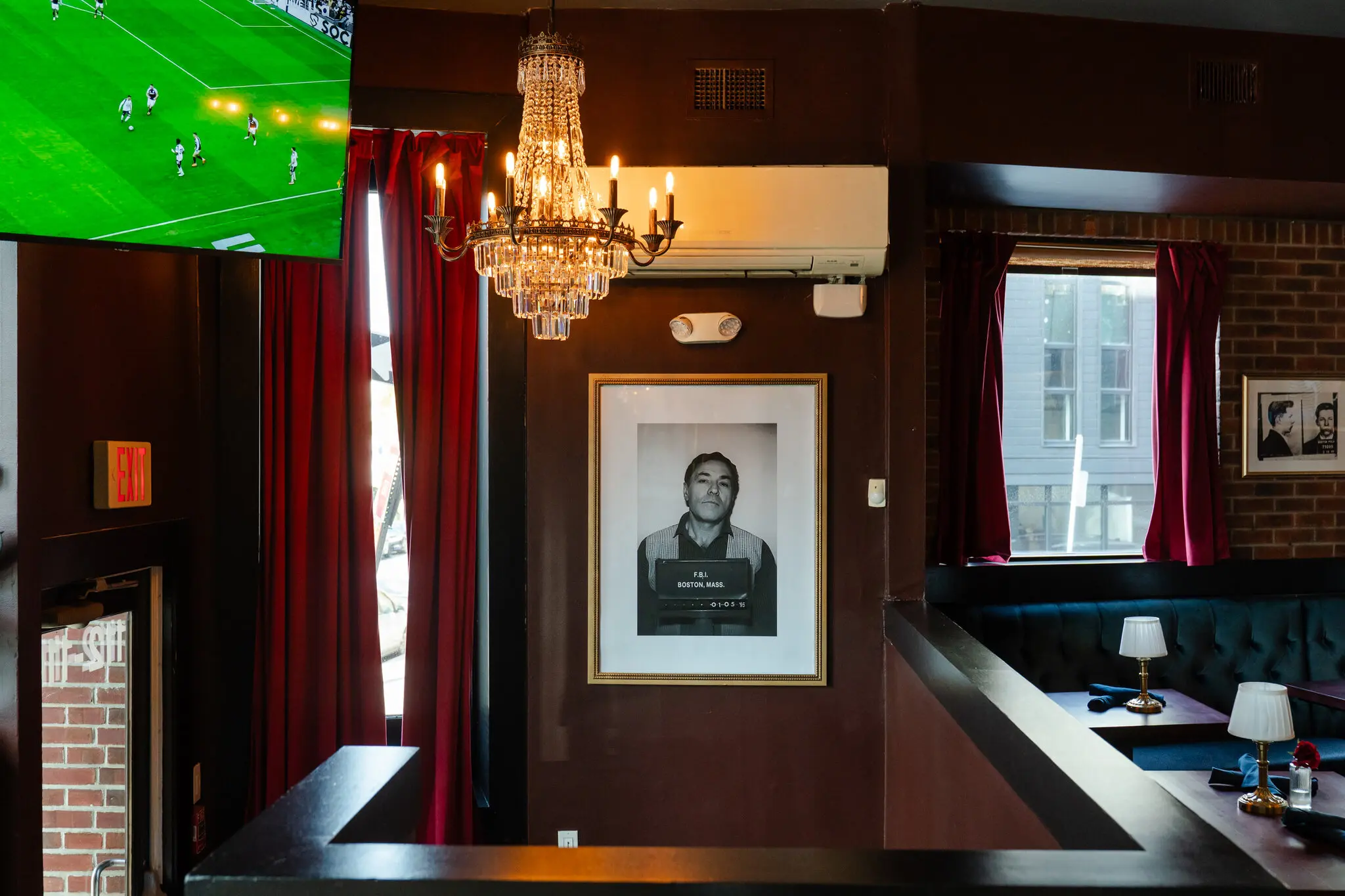 Photos of Stephen “The Rifleman” Flemmi, center, and James “Whitey” Bulger, right, were put up as part of a renovation this year at Savin Bar &amp; Kitchen in Boston.