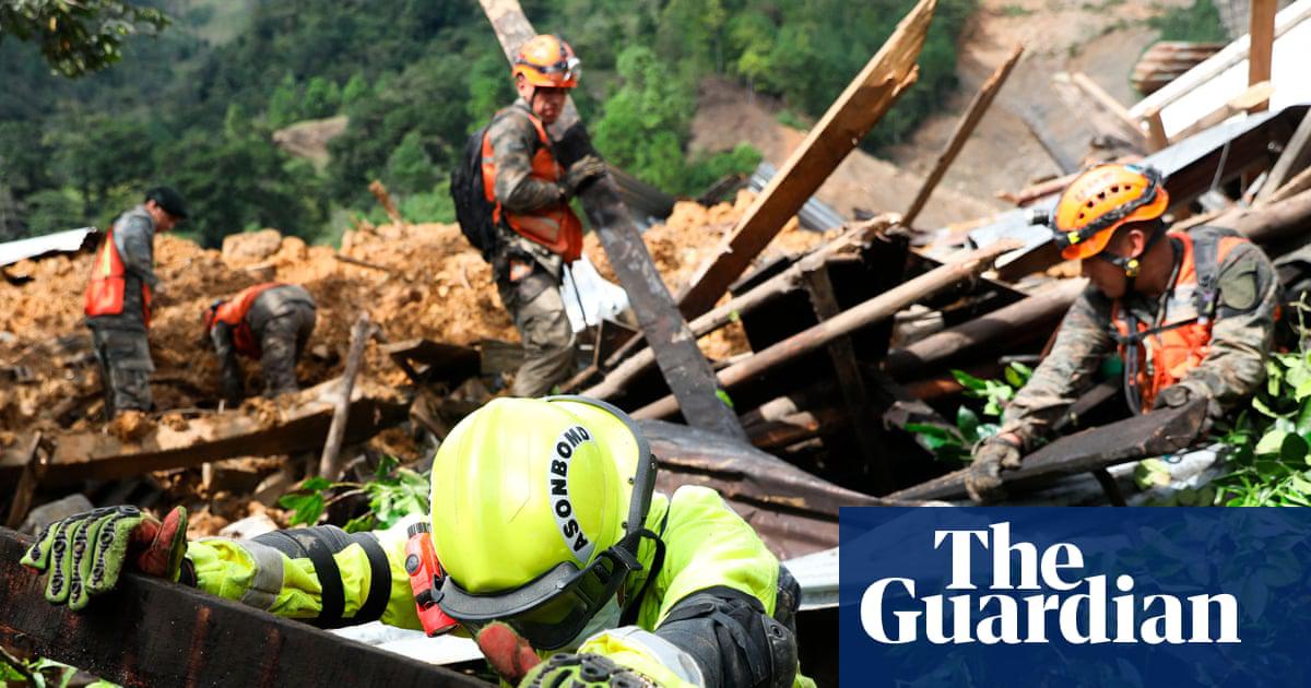 Rescue workers search for victims of a mudslide caused by the passage of Hurricane Eta in the village of Queja, in San Cristóbal Verapaz, Guatemala on 7 November 2020.