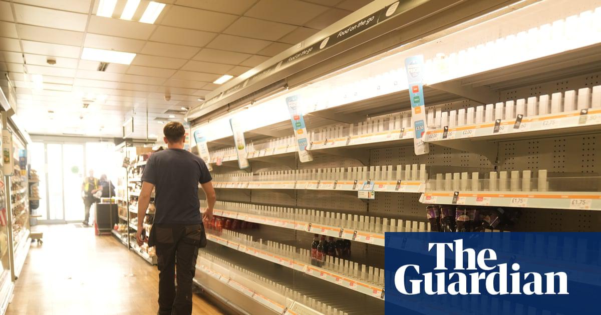 A man walks past empty shelves in a branch of the Co-op in Manchester after a cyber-attack.