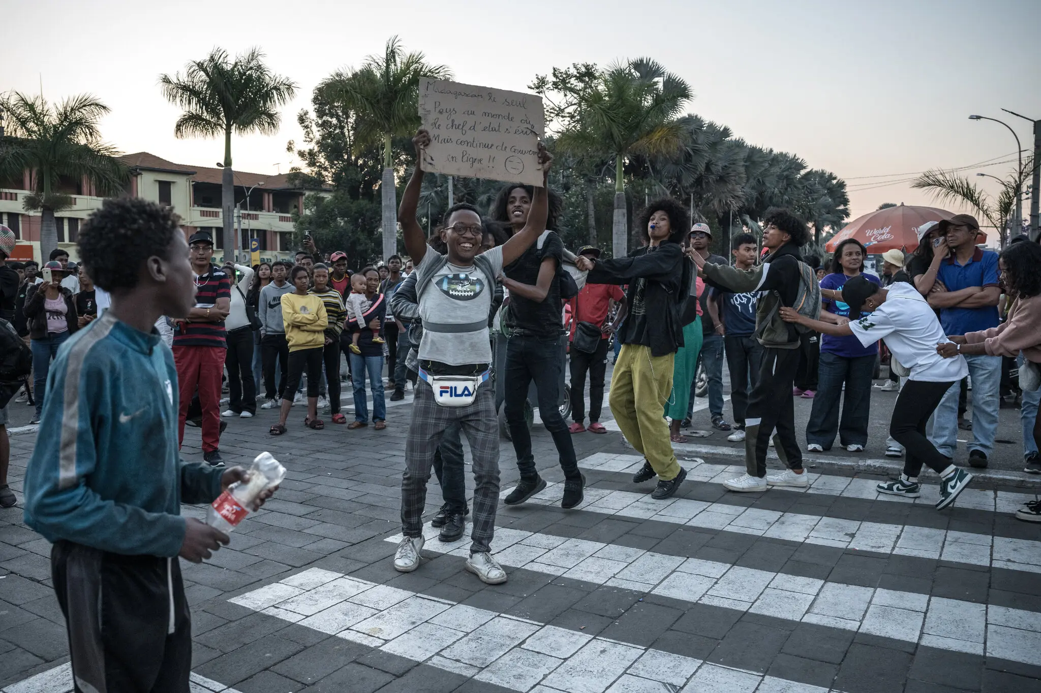 Anja’ndraina Andrianaivo, a Gen Z organizer, center, celebrating on Tuesday in Madagascar’s capital after its Parliament impeached President Andry Rajoelina.