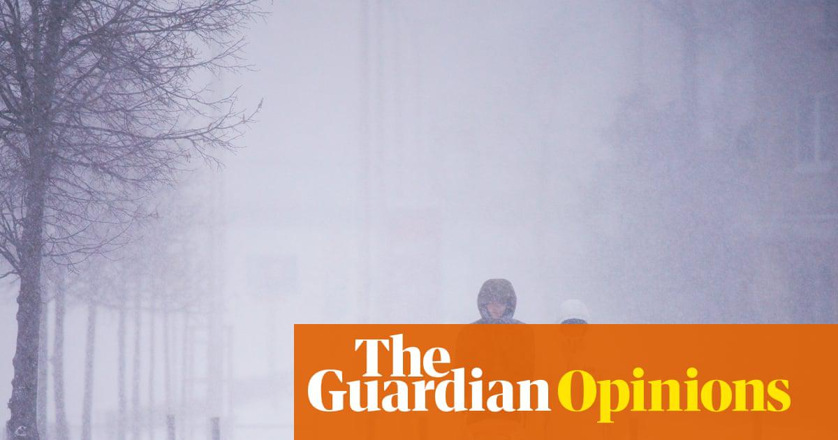 A couple out walking their baby in heavy snow in Warsaw, Poland, during January 2021. 