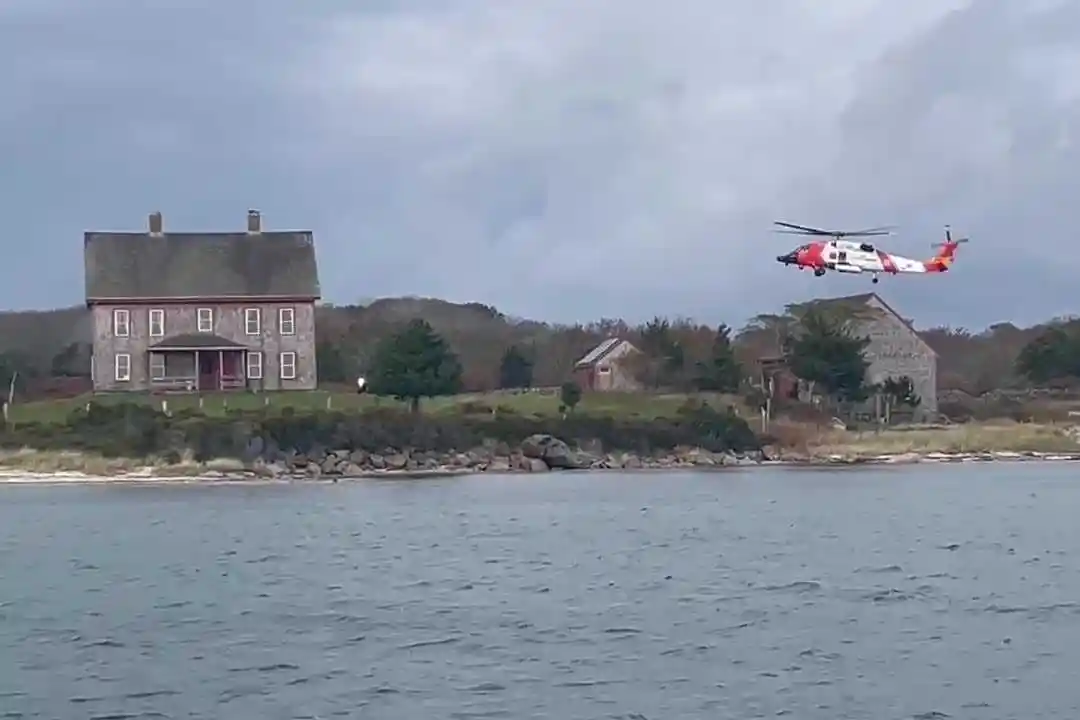 A Coast Guard helicopter crew rescued three members of a family who found refuge on Naushon, a sparsely populated island off Martha’s Vineyard, after their boat burned and sank.