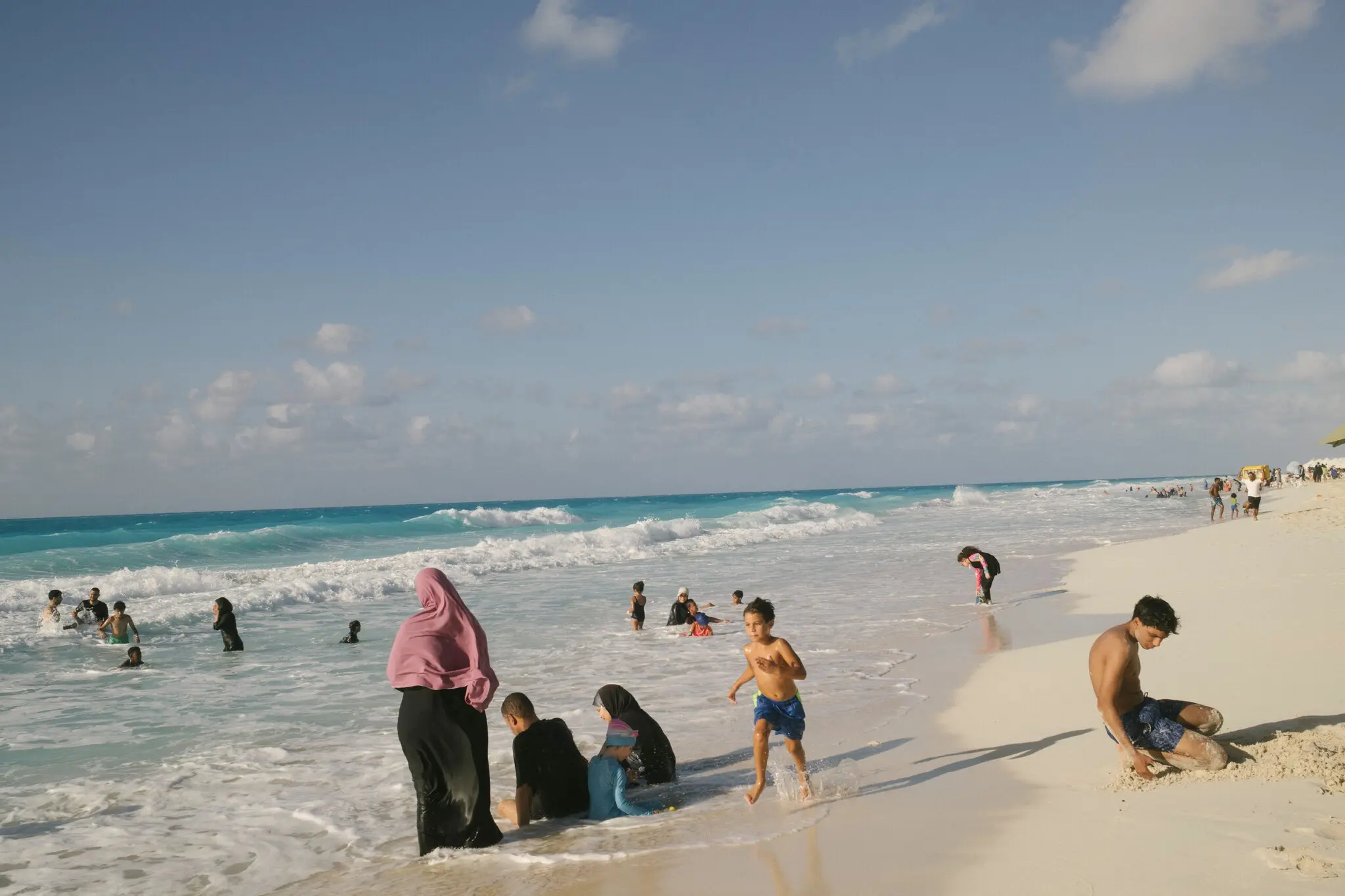 People enjoying the beach in Sahel el-Tayeb, a village along Egypt’s northern Mediterranean coast that caters to less wealthy residents and visitors, in July.