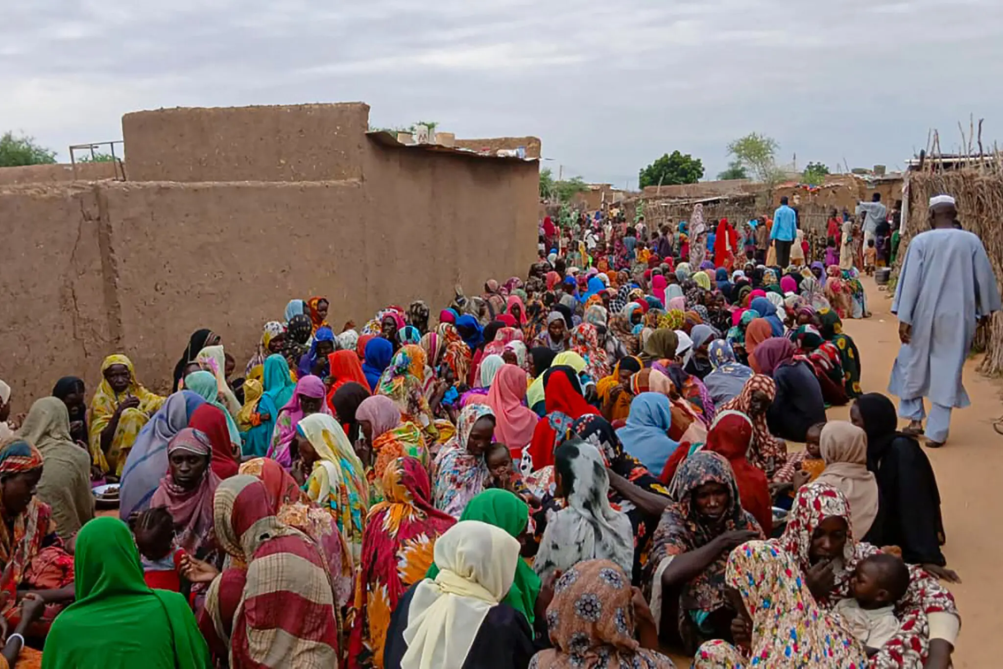 Sudanese residents gathered in August to receive food in El Fasher, a city in Darfur that has been under a siege by the paramilitary Rapid Support Forces.