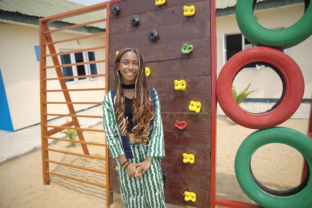 Amara Nwuneli stands in front of a climbing wall at a former dump that she helped transform into a park in Lagos, Nigeria. 