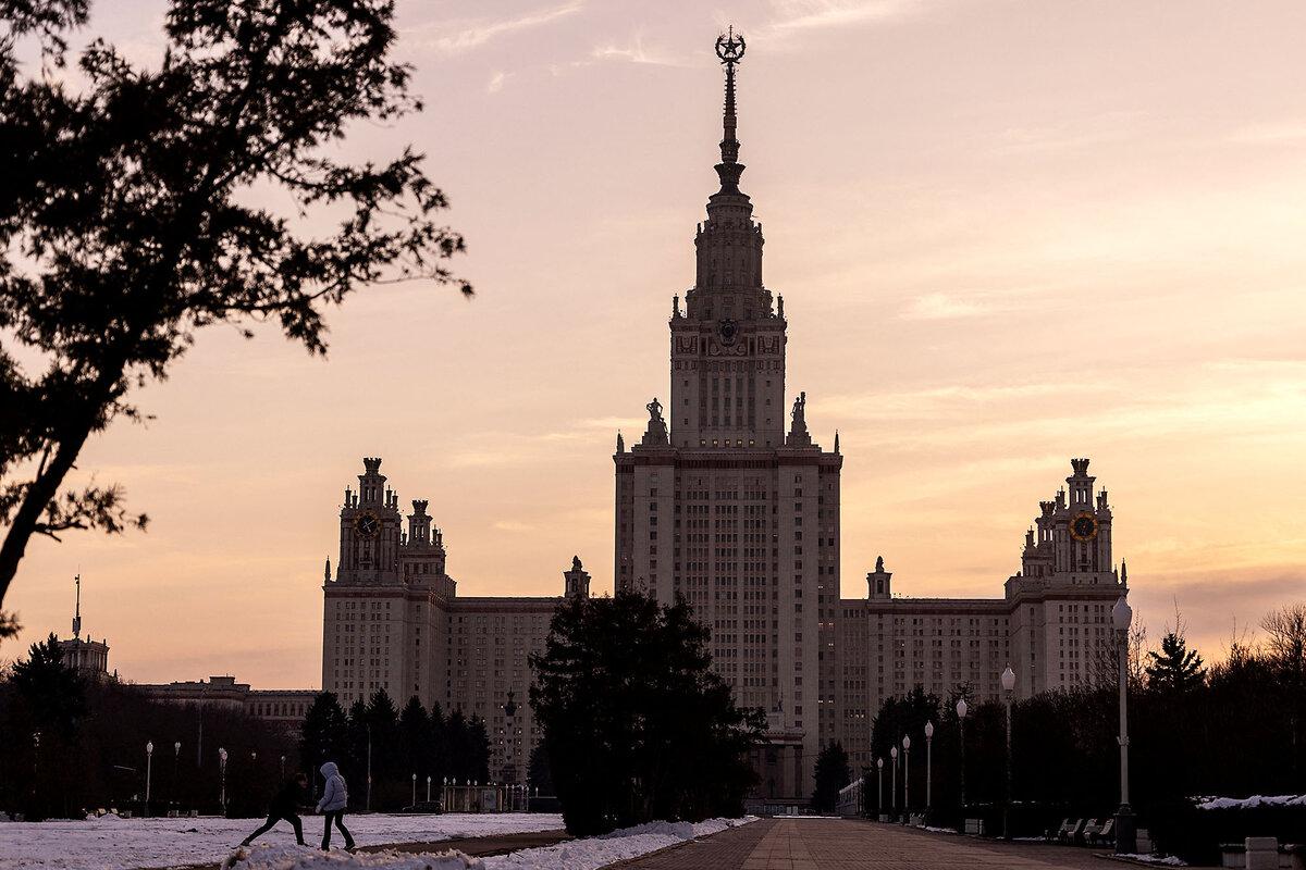 People walk in front of Moscow State University's main building at sunset in Moscow, Feb. 28, 2025.