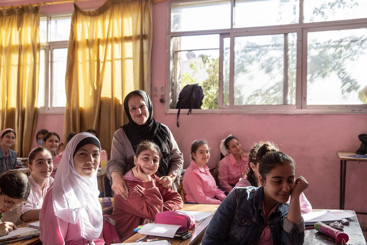 A teacher poses for a photo in a girls' classroom in Homs, Syria, Oct. 3, 2025.