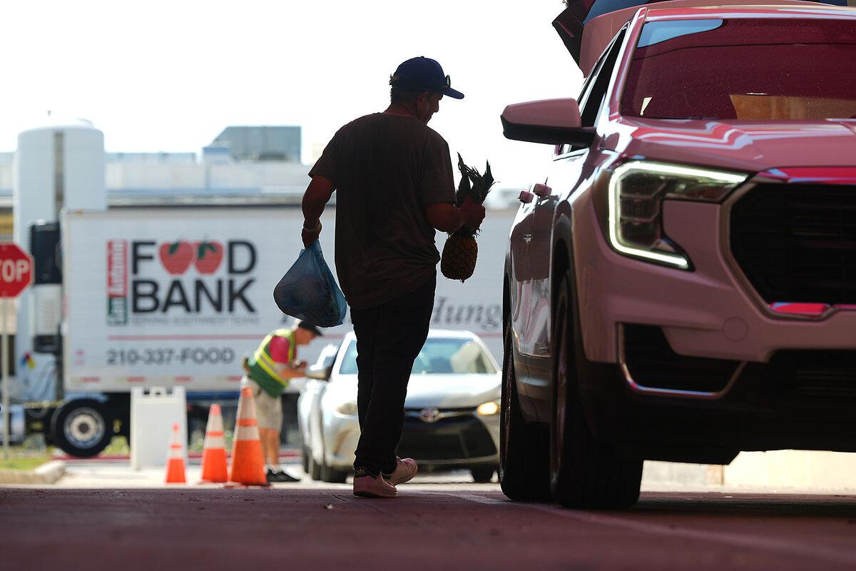 Volunteer Joel Hernandez helps load a vehicle during a food distribution targeting federal employee households affected by the government shutdown, as well as SNAP recipients, Oct. 27, 2025, in San Antonio.