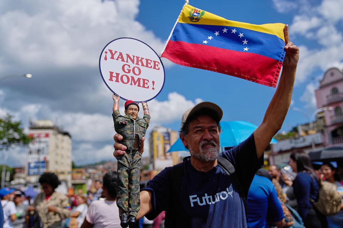 A man holds a doll of former President Hugo Chávez near a United Nations office in Caracas, Venezuela, during a government-organized rally against foreign interference, Oct. 6, 2025. 