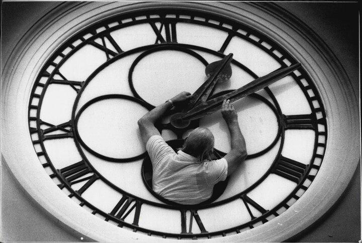 Horologist Lawrie Taprell adjusts the clock atop the North Sydney Post Office in Australia in 1989. Twice a year, clockkeepers like Taprell fine-tune public timepieces to match daylight saving shifts—something the U.S. once tried to make permanent.