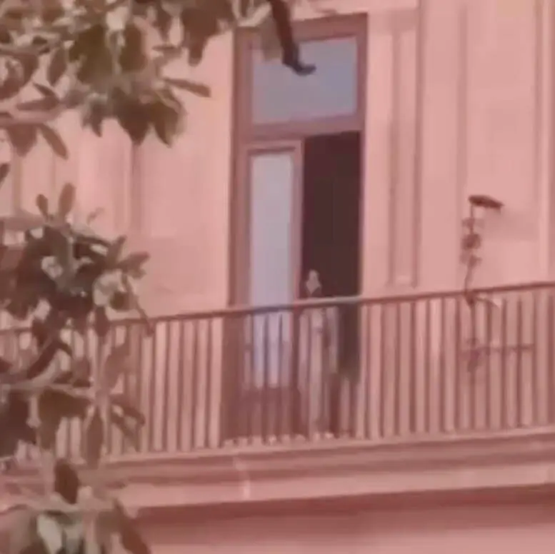 A figure in a window of a government building, as seen from a protest in San Luis Potosí, Mexico.