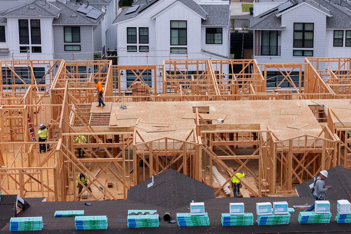 Construction workers frame out a multi-home residential project in Encinitas, California, July 21, 2025.