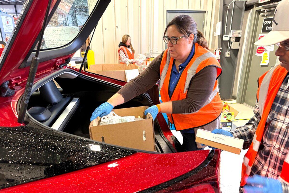 Employees at The Food Bank Inc. load food into a car in Dayton, Ohio, Oct. 30.