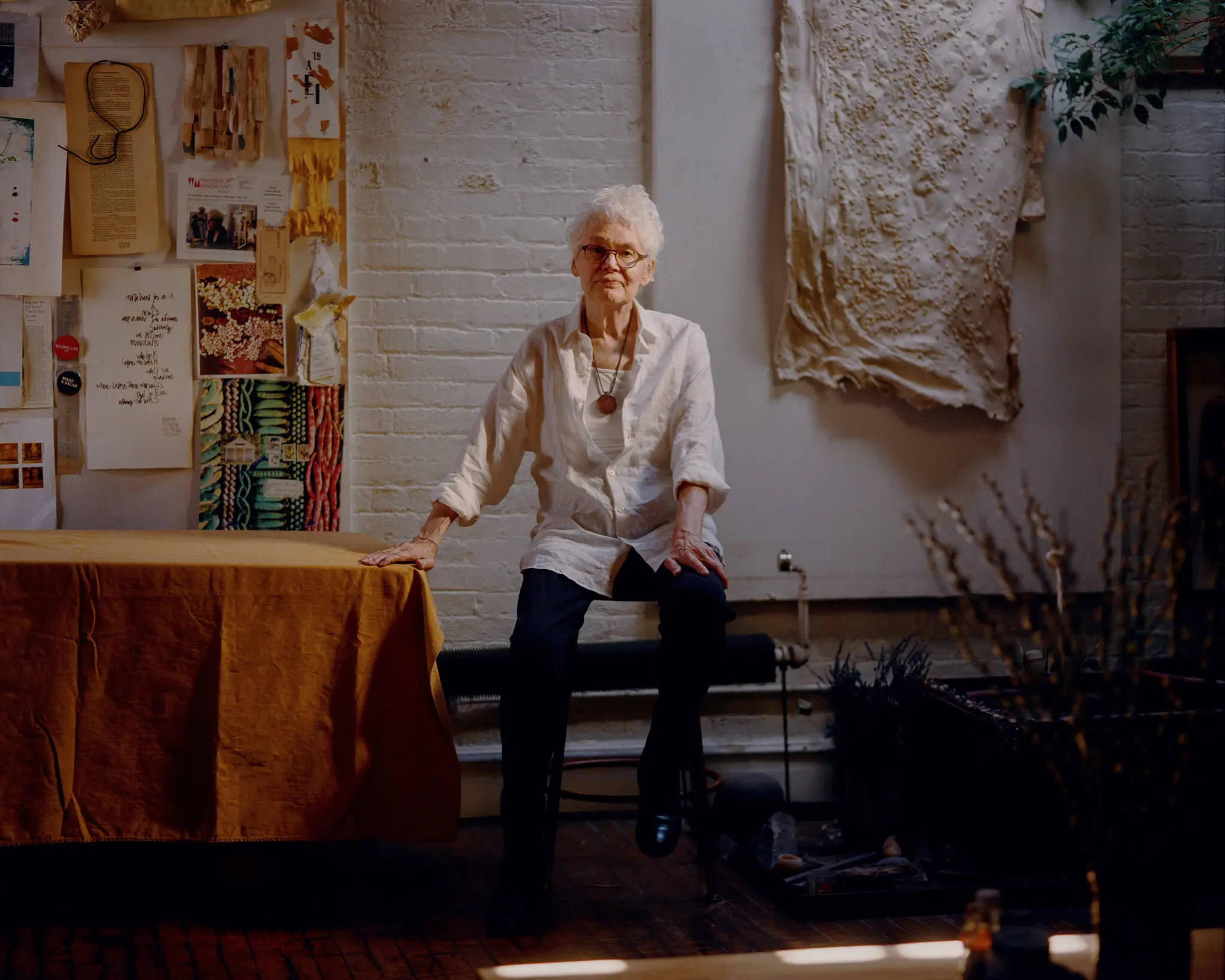 The artist Alison Knowles in front of some of her work at her Manhattan studio in 2022. She was best known for a style of interactive art that by design is challenging to display and preserve in a museum.