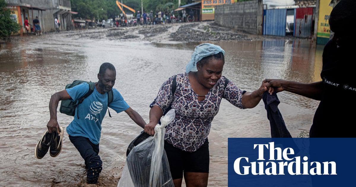 People on a flooded street in Petit-Goave, Haiti.