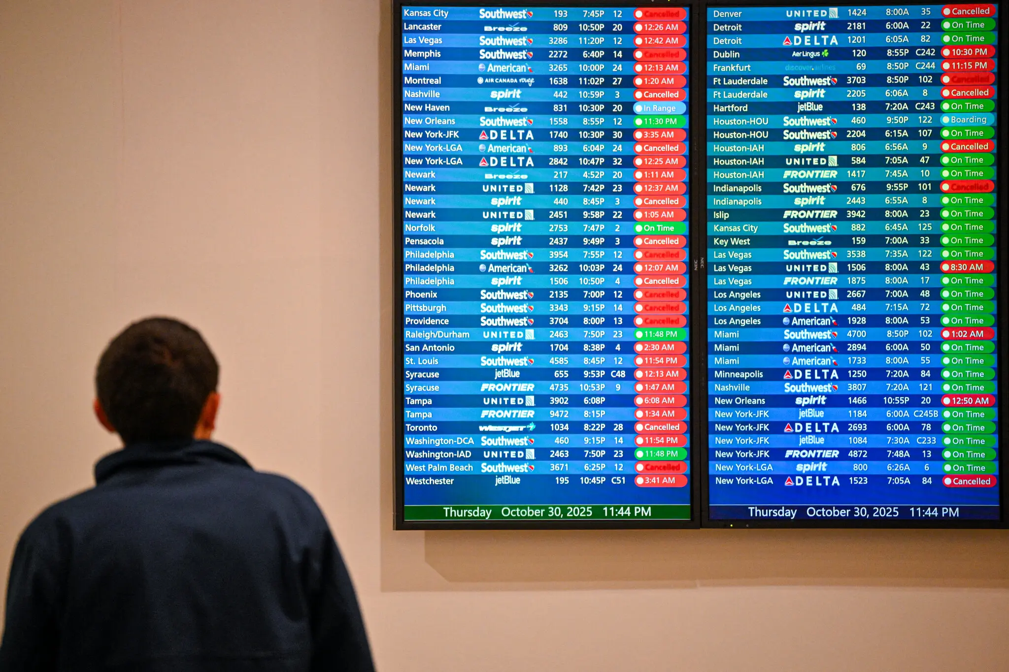 Canceled and delayed flights, listed in red, on a message board at Orlando International Airport on Thursday.