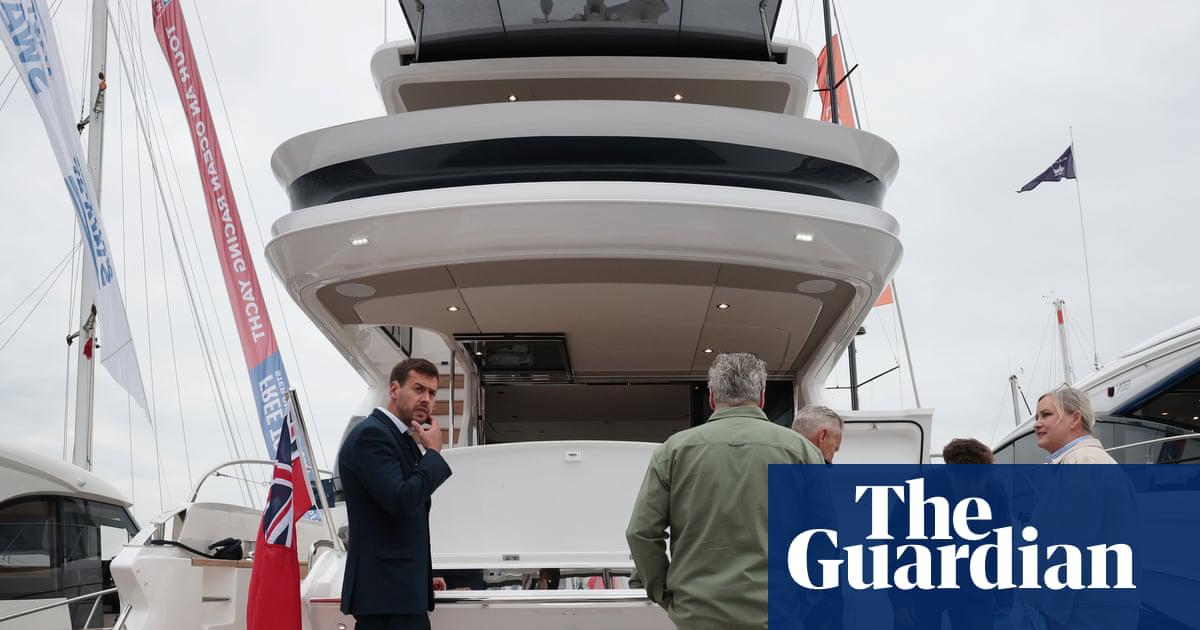 Prospective buyers consider a superyacht at the Southampton International Boat Show.