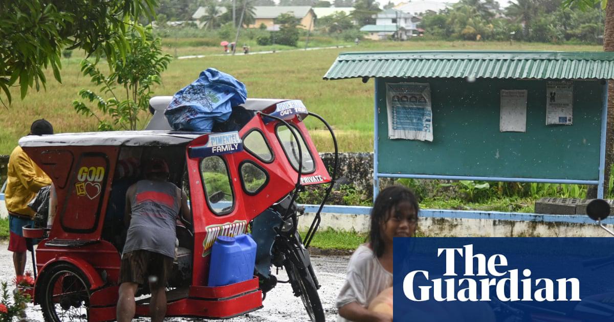 People take shelter at a school as they evacuate in Balangkayan in eastern Samar as Tropical Cyclone Tino approaches.