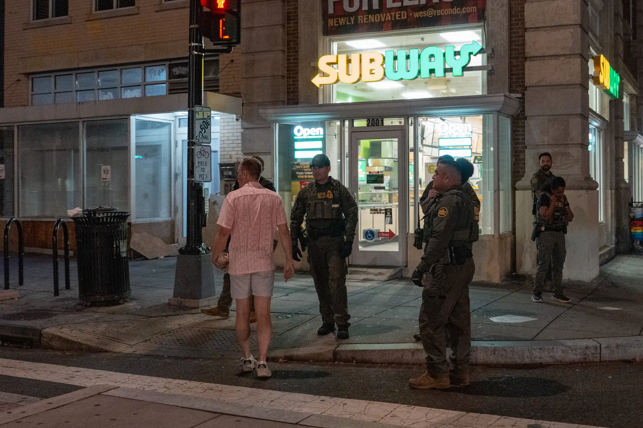 A man, later identified as Sean C. Dunn, seen approaching federal agents while holding a sandwich in Washington in August. He was later arrested, accused of throwing the item at an officer.