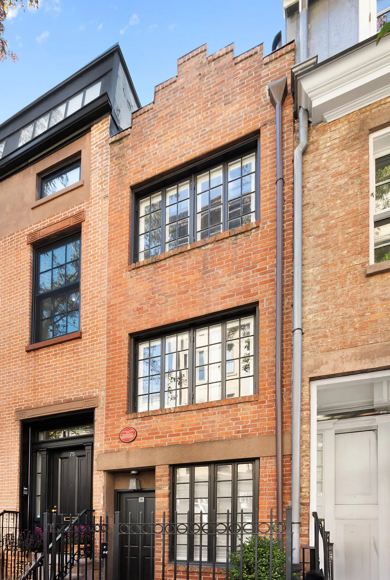The red brick townhouse, built in 1873, is just 9.5 feet wide.