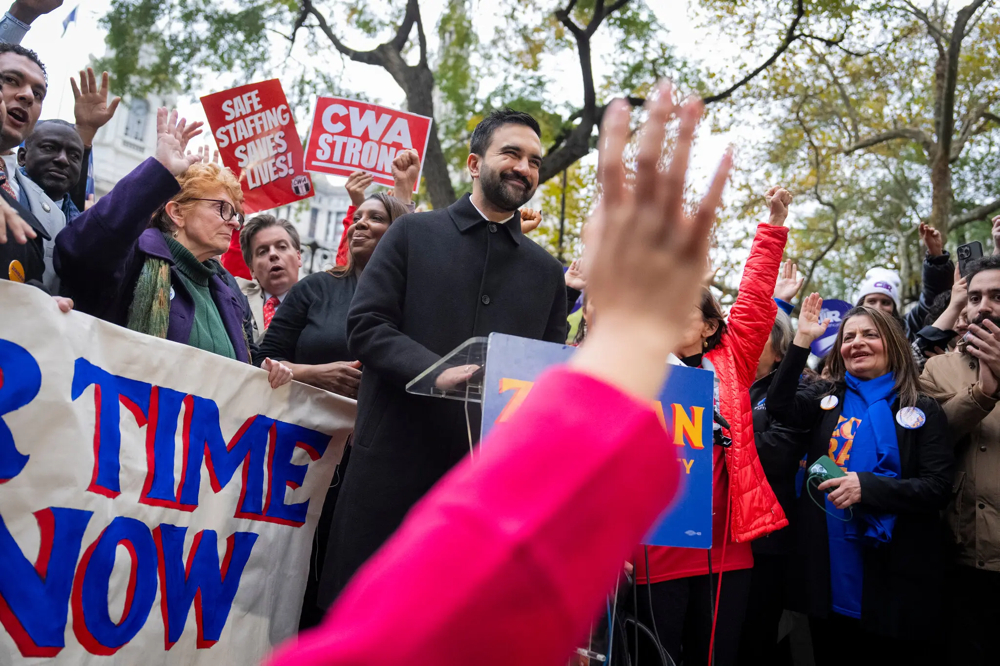 Zohran Mamdani began Monday leading a sunrise walk across the Brooklyn Bridge, culminating in a news conference at City Hall Park that drew various public officials, including Letitia James, the state attorney general.