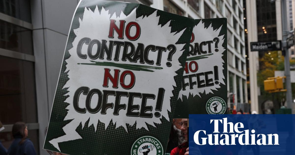 Starbucks baristas gather protest against the company during a rally to demand a new contract in New York on 28 October 2025.