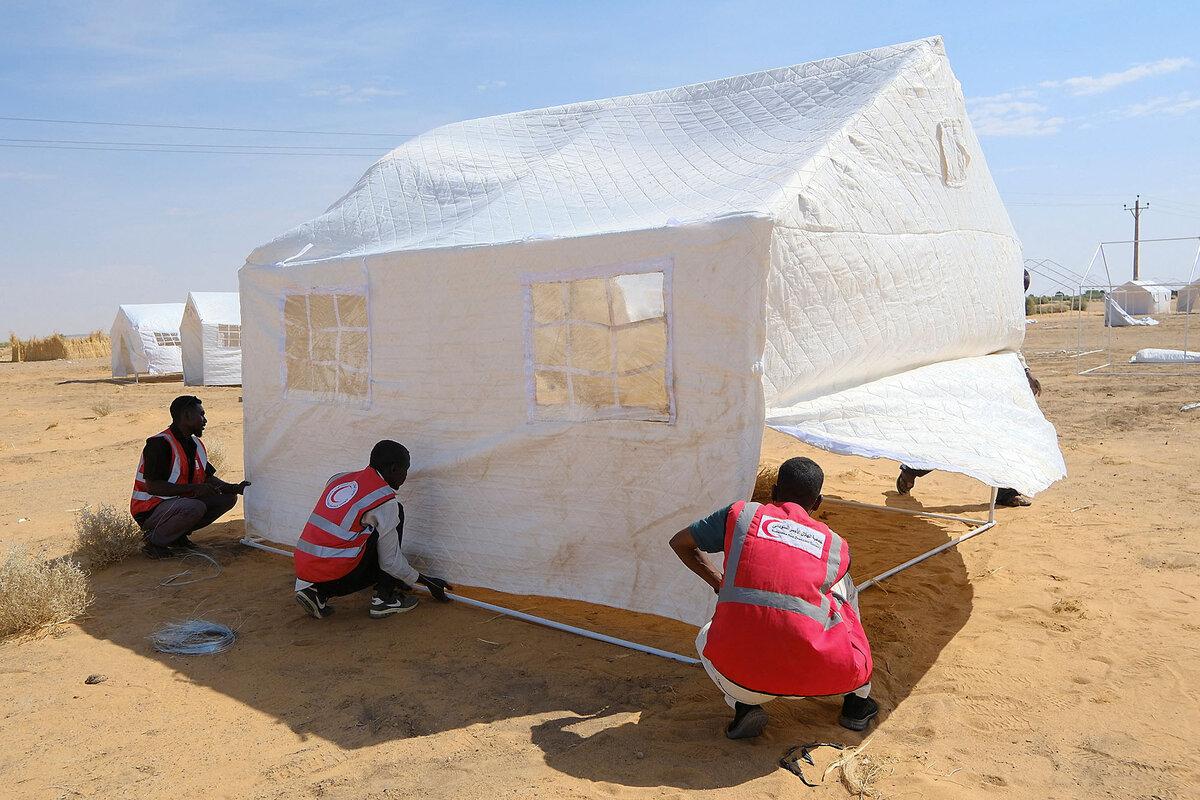 Volunteers from the Sudanese Red Crescent set up tents for people who are displaced from El Fasher, Sudan, Nov. 3, 2025.