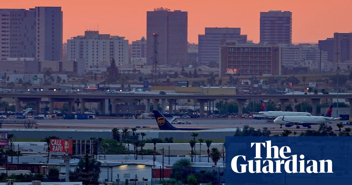 A sign displays a temperature of 108F as jets taxi at Sky Harbor International Airport in Phoenix.