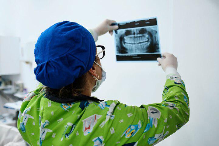 A dentist reviews a dental X-ray. Researchers are increasingly finding that oral health may offer early clues to disease elsewhere in the body.