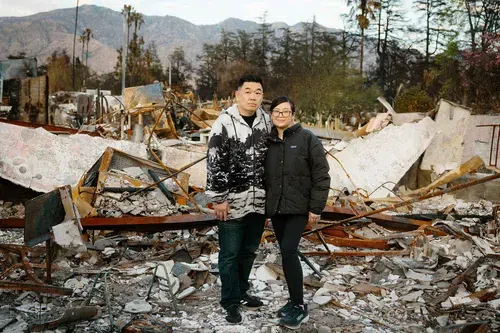 Chien (left) and Kim Yu in front of the ruins of their home in Altadena, California.
