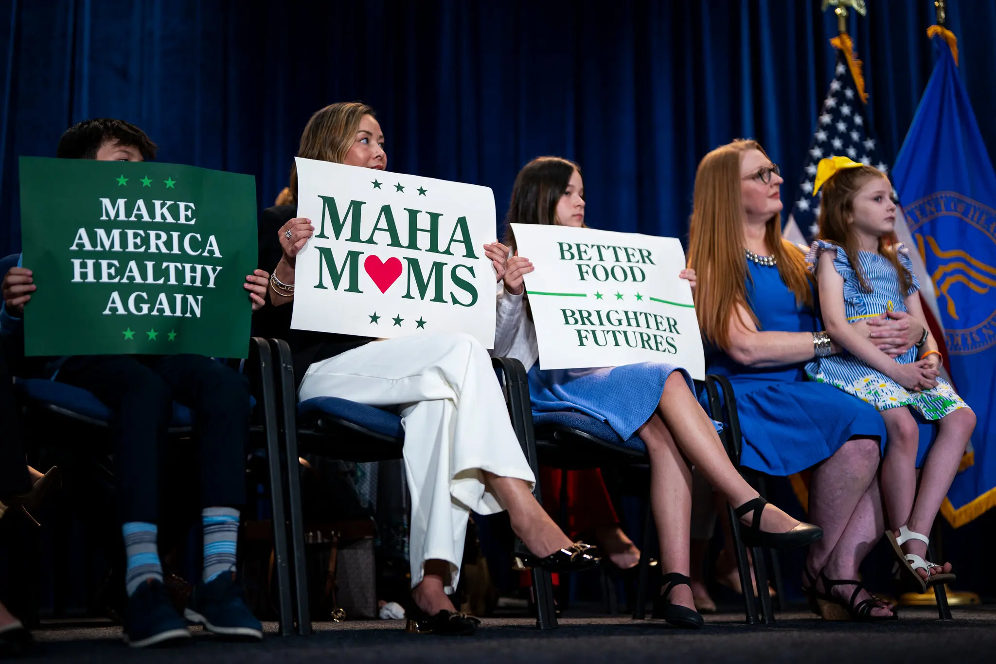 Supporters of Health Secretary Robert F. Kennedy Jr. onstage with him at a news conference last year.