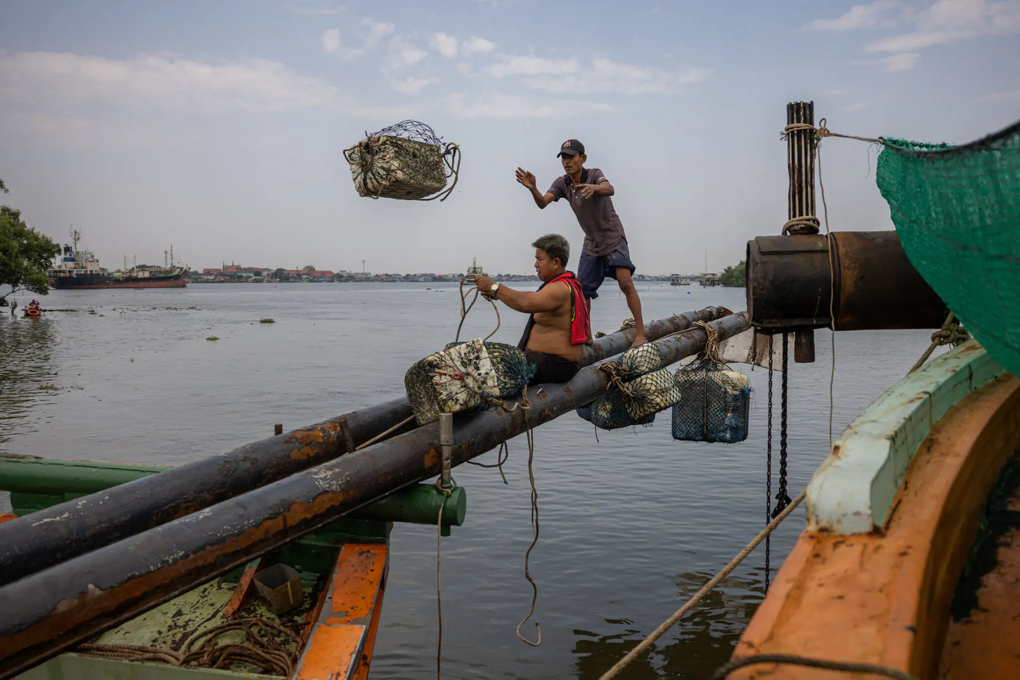 Fishermen on their boats while docked and unable to go out to sea due to diesel shortages and high prices, in Samut Sakhon, Thailand, on Monday.