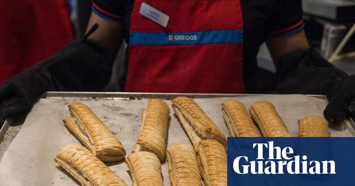 An employee holds a tray of freshly baked Vegan sausage rolls at a Greggs. The CEO also said the firm would see how inflation evolves as it negotiates a pay rise for workers this year.