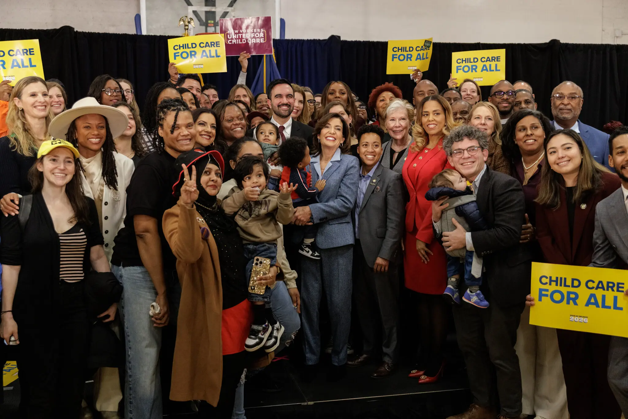 The announcement came days into the term of Mayor Zohran Mamdani, center, a democratic socialist who ran on a promise to make child care free for all New York City children under 5.
