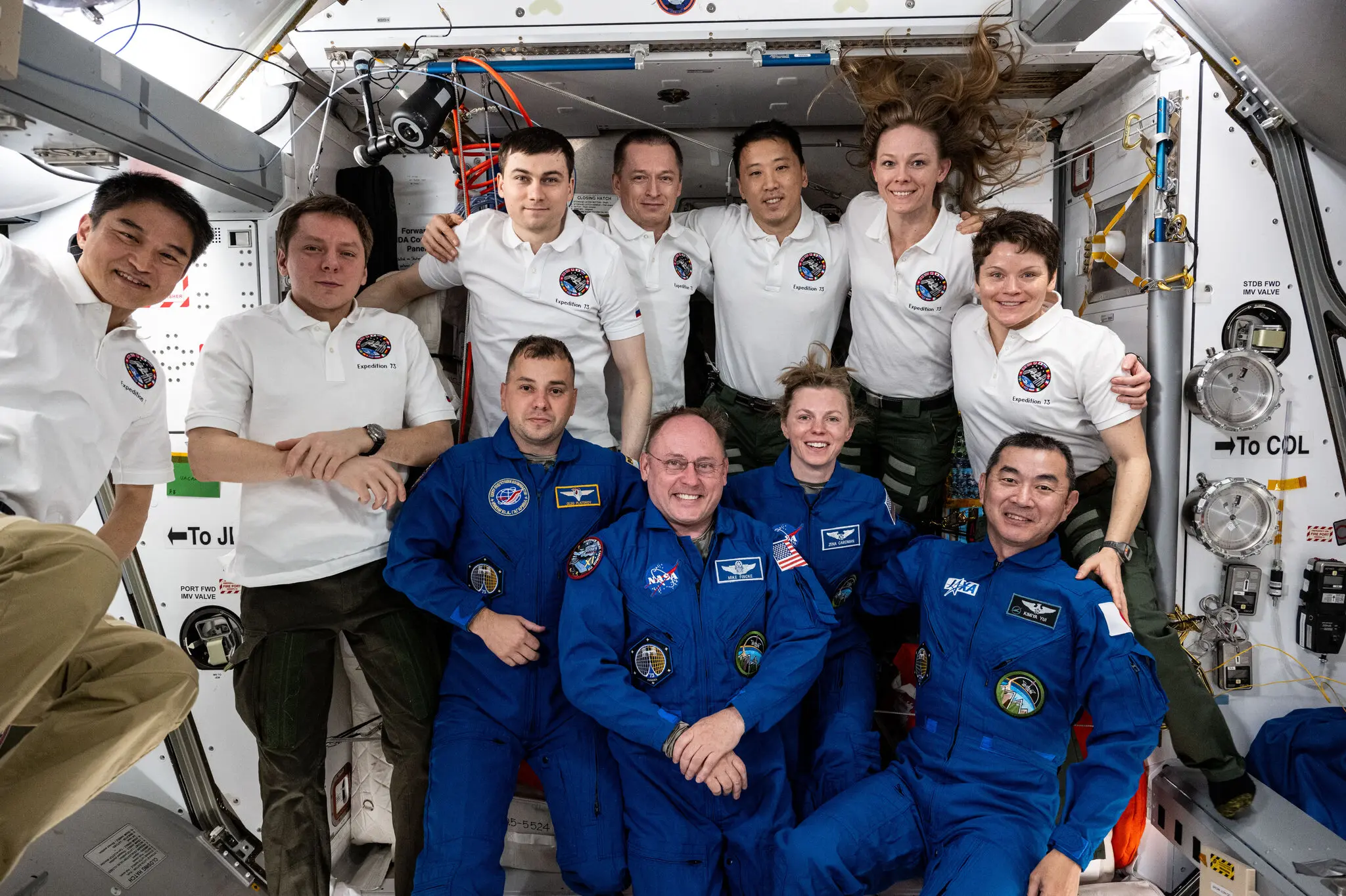 The four astronauts on the Crew-11 mission, in blue, launched into space on Aug. 1 and were expected to spend about six months at the International Space Station.