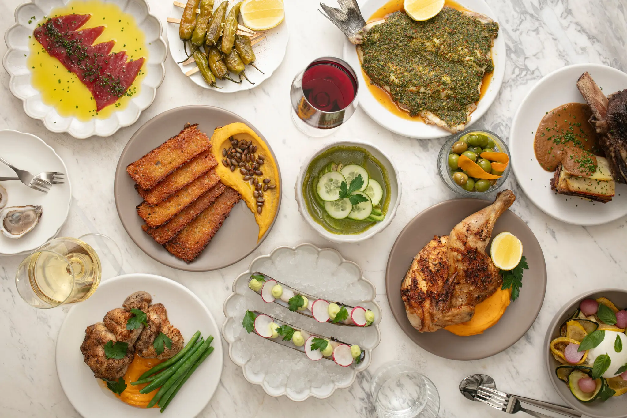 The spread at Aperitivo by Carta includes crowd-pleasers like roast chicken and a copious raw bar selection.
