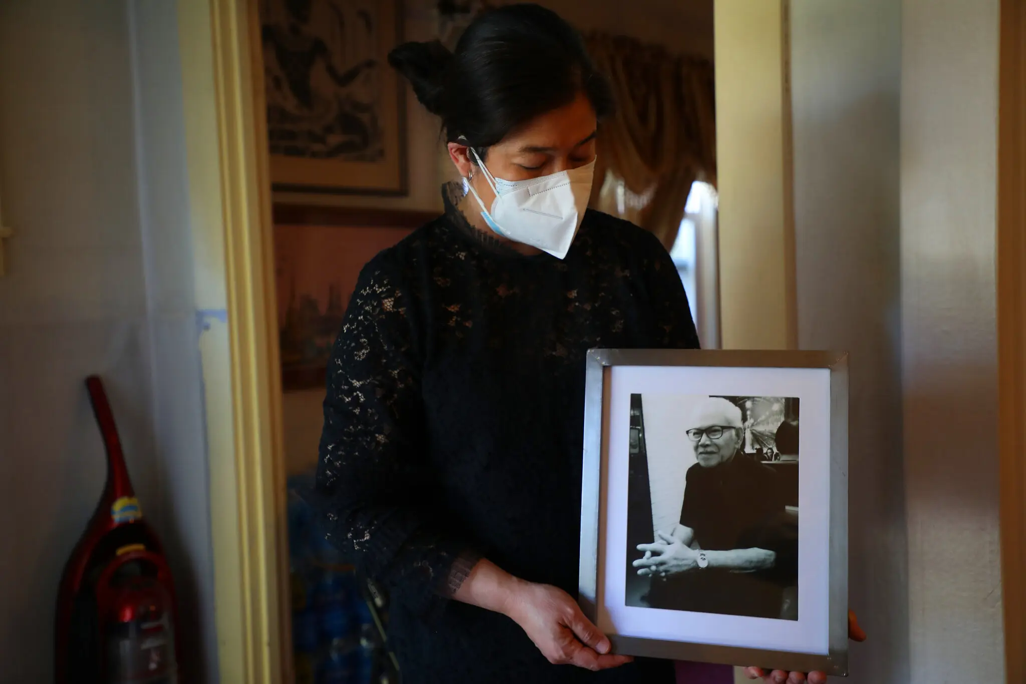 Monthanus Ratanapakdee with a picture of her father, Vicha Ratanapakdee, in 2021. Mr. Ratanapakdee was shoved to the ground while out on a walk in San Francisco that year, and died from his injuries.